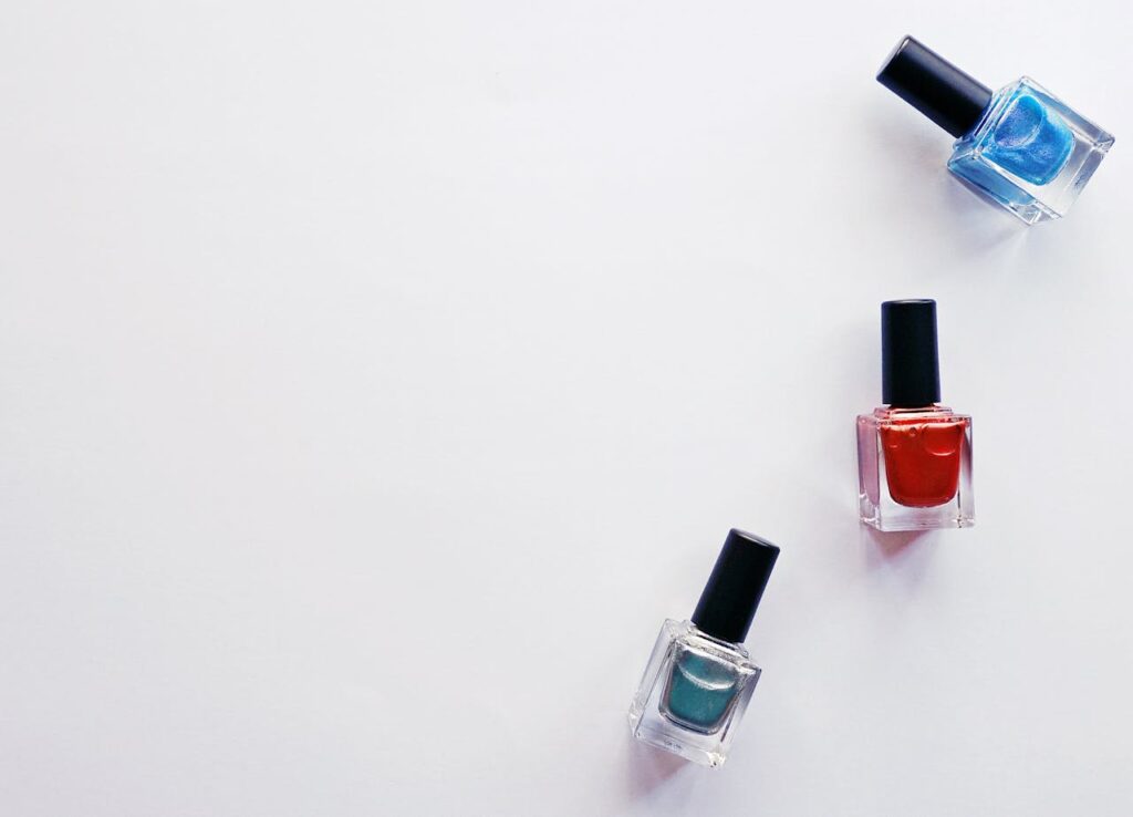 Crafting Captivating Headlines: Your awesome post title goes here Three colorful nail polish bottles arranged creatively on a white backdrop, showcasing vibrant beauty products.